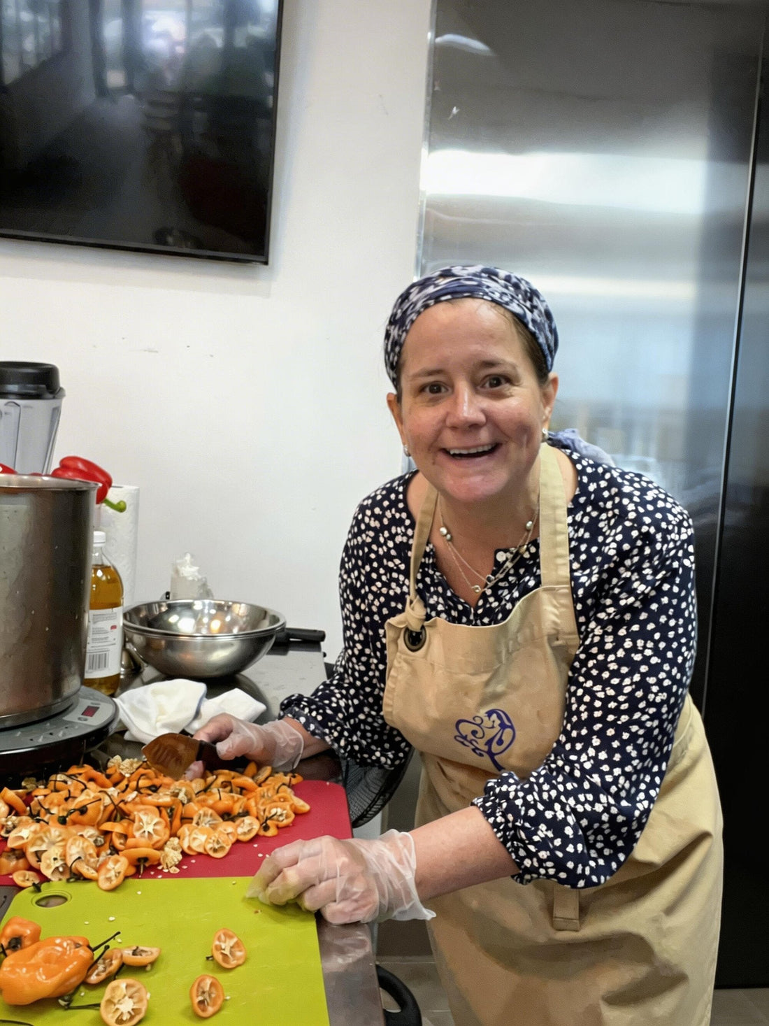 Chef Melissa Fox in the kitchen preparing habaneros for Fox Gourmet products