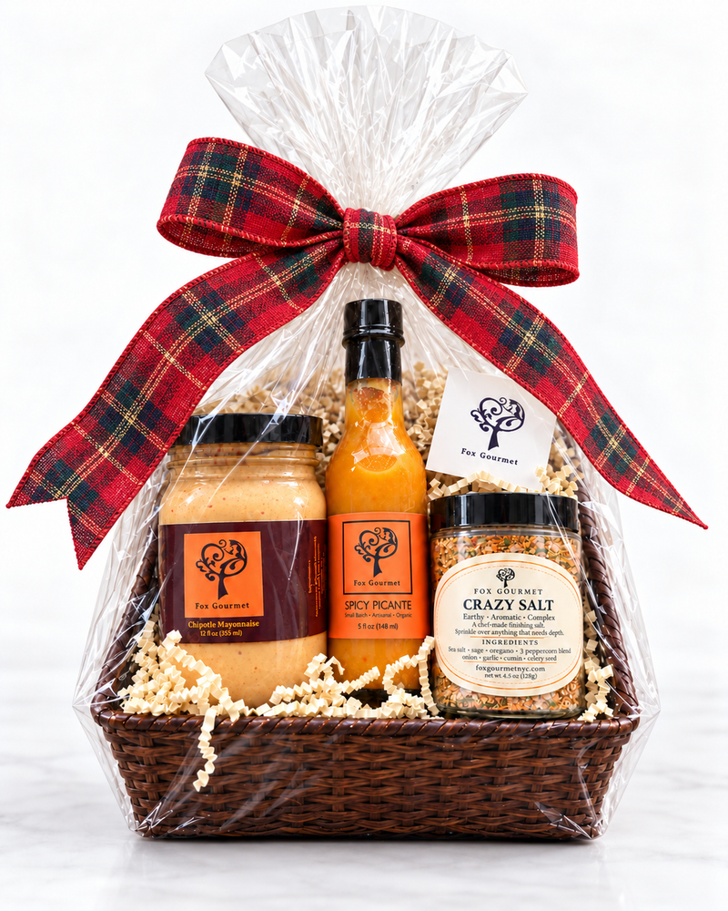 The Essentials Gift Box: Chipotle Mayonnaise, Spicy Picante and Crazy Salt in a wrapped basket with a red plaid bow